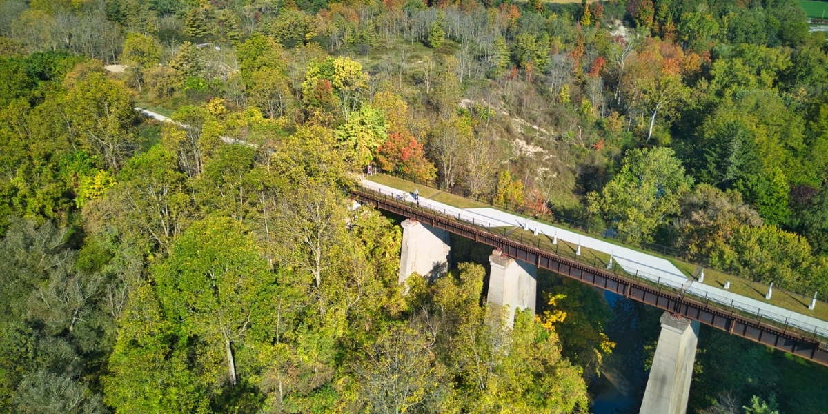 long train track birdseye view surrounded by fall foliage