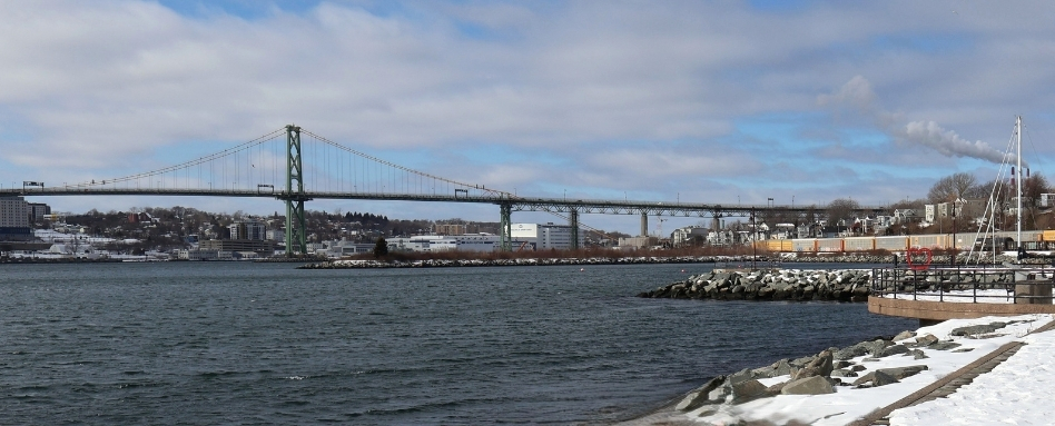 long bridge over water on snowy day