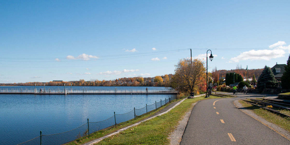 QC - La Montérégiade - Granby | Trans Canada Trail long bike pathway alongside waterfront trees
