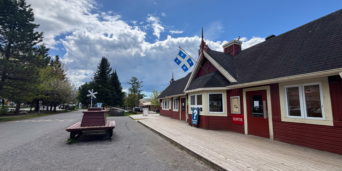 large house and quebec flag on a partly cloudy day