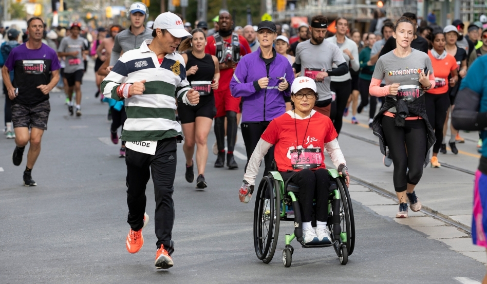02Support image_Jen Cerullo profile_credit Canada Running Series | Trans Canada Trail person jogging alongside person in a wheelchair