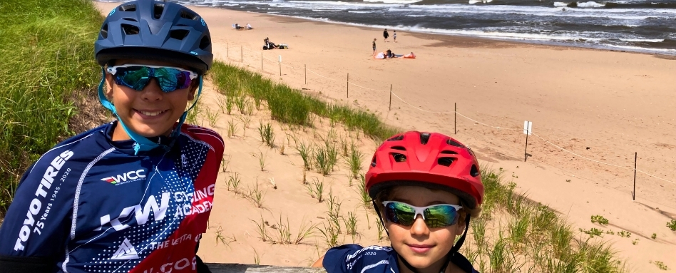 selfie of mother and son in front of sandy beach