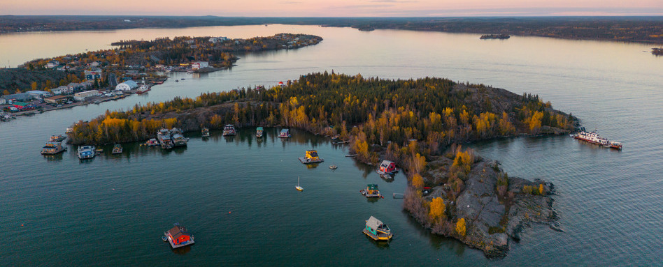 birdseye of island township at sunset with fall foliage