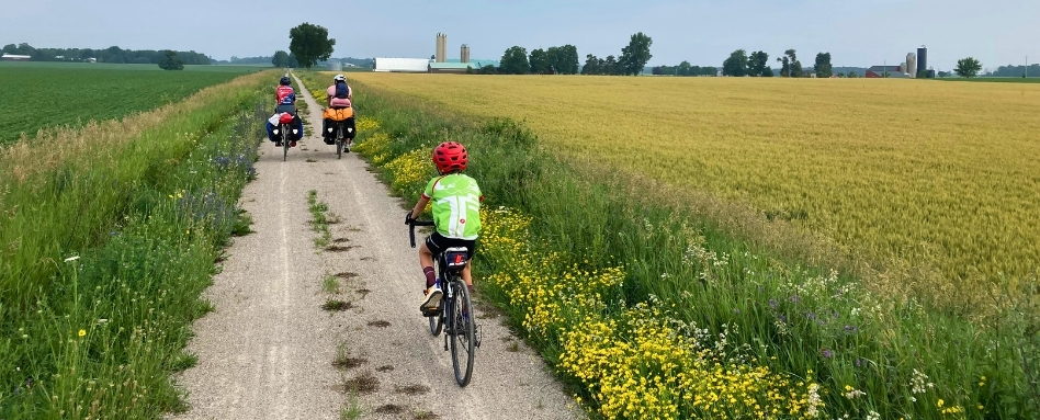 family cycling through large field