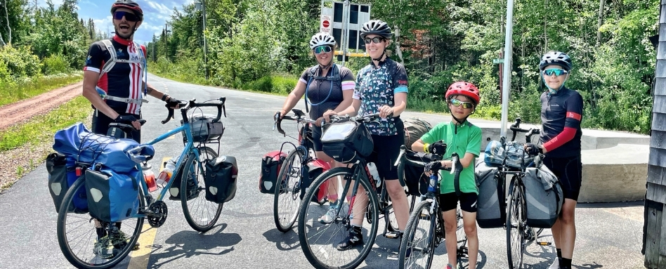 photo of family on bikes posing with biking gear