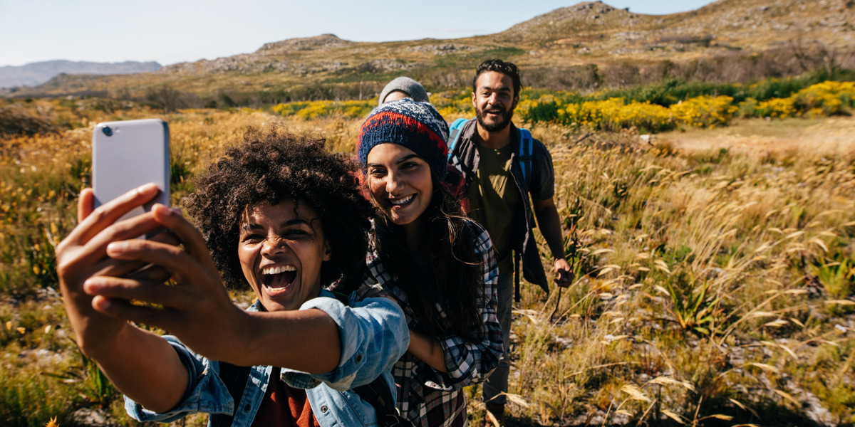 00Feature image_Early registration | Trans Canada Trail three people in a field taking a joyful selfie
