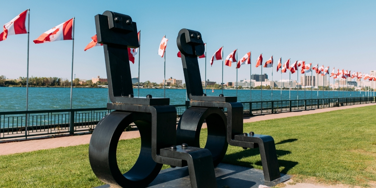 00Feature image_ON_TWEPI article_Windsor waterfroont_credit Tourism Windsor Essex Pelee Island | Trans Canada Trail statues waterfront with canadian flags behind
