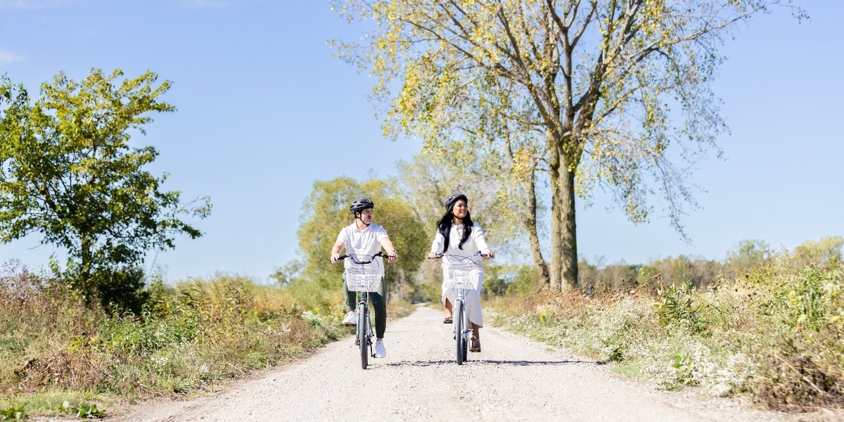 00Feature image_Pelee Island trail profile_credit Tourism Windsor Essex Pelee Island | Trans Canada Trail two people riding a bike on a paved trail on a sunny day
