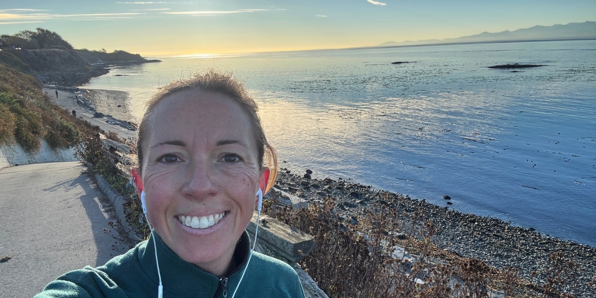 woman taking a selfie with seaview on a board walk