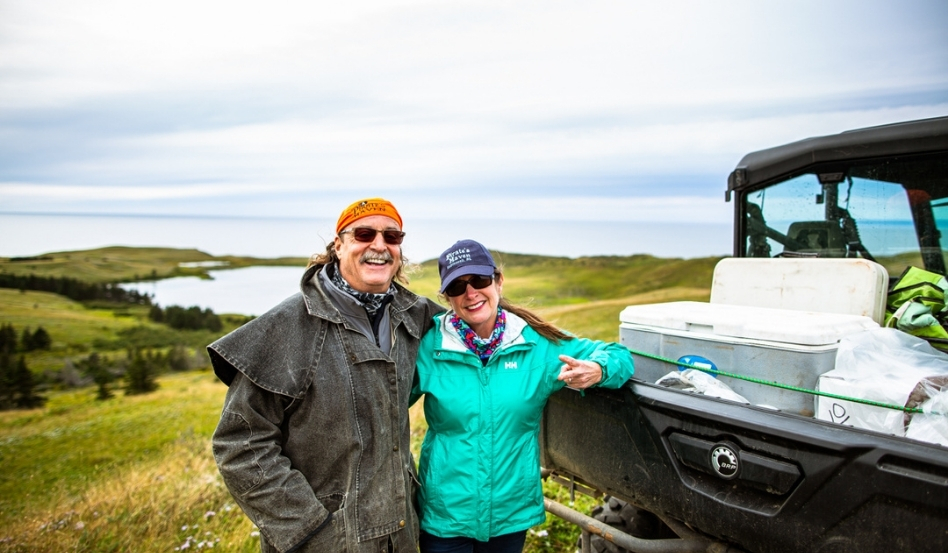 two people smiling infront of coastal views and rolling hills