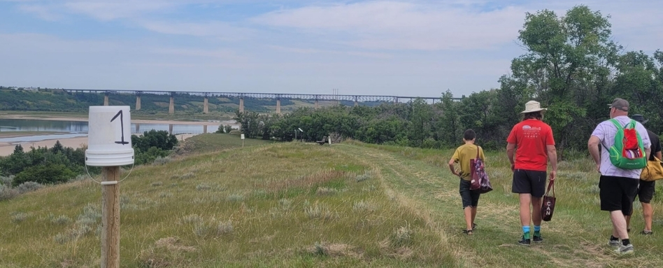 A group walking along a grassy trail