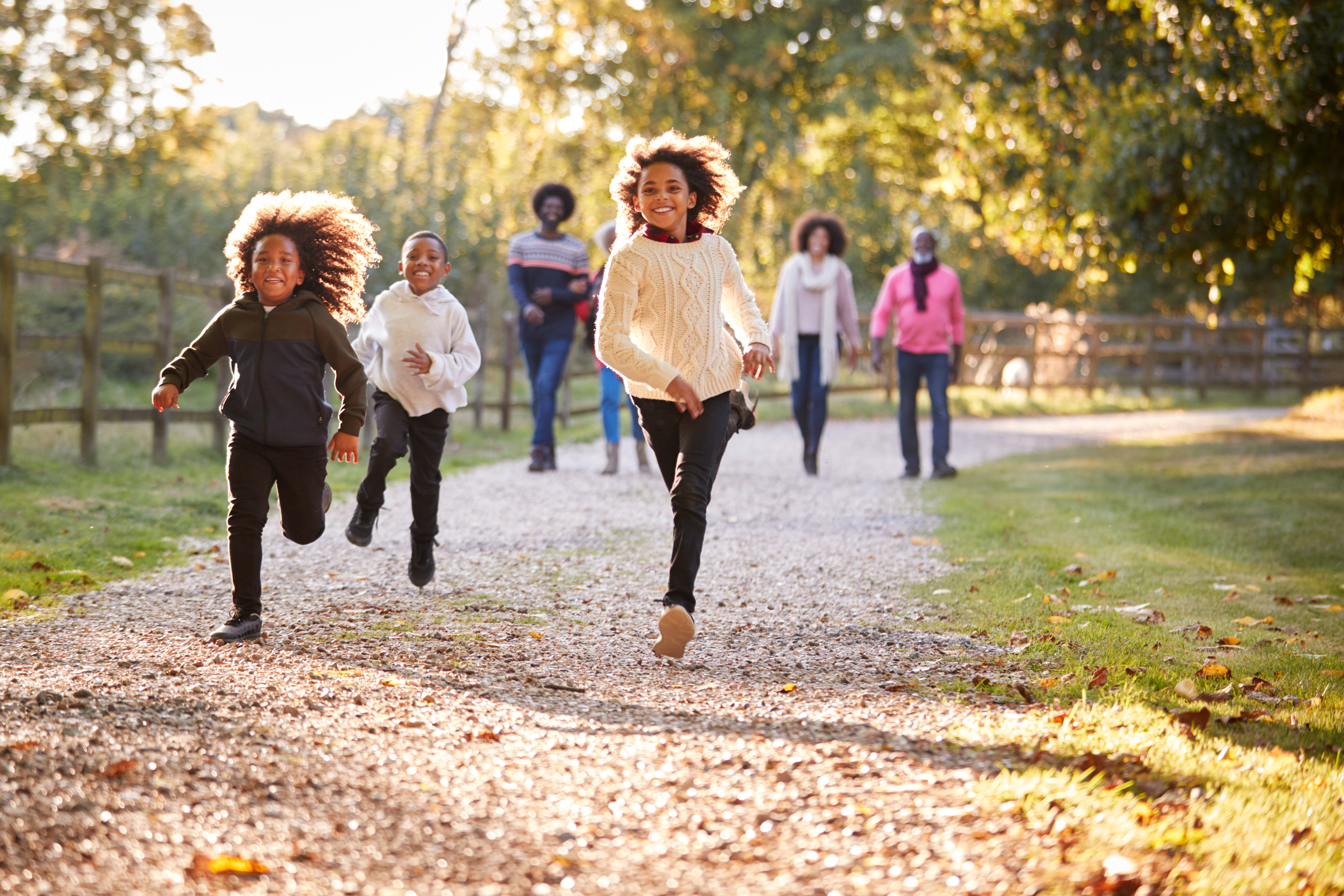 children running playfully on a fall day