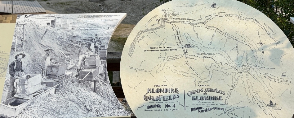 Historical signage depicting the history of Dawson City