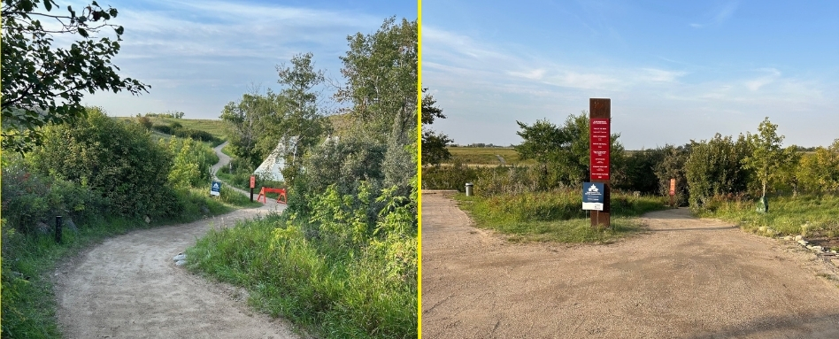 Two dirt trails split in a grassy countryside; left path curves through bushes with a blue sign, right path ahead with open fields beyond.